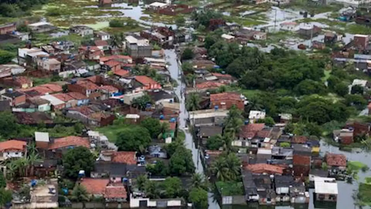 Brazil's Bolsonaro surveys disaster area after rains kill nearly 100