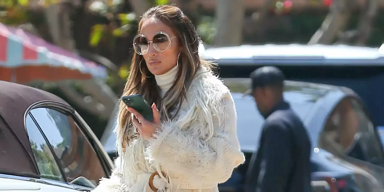 Jennifer Lopez Channeled a ‘70s Movie Star in a Fringe Belted Coat and Tan Skirt