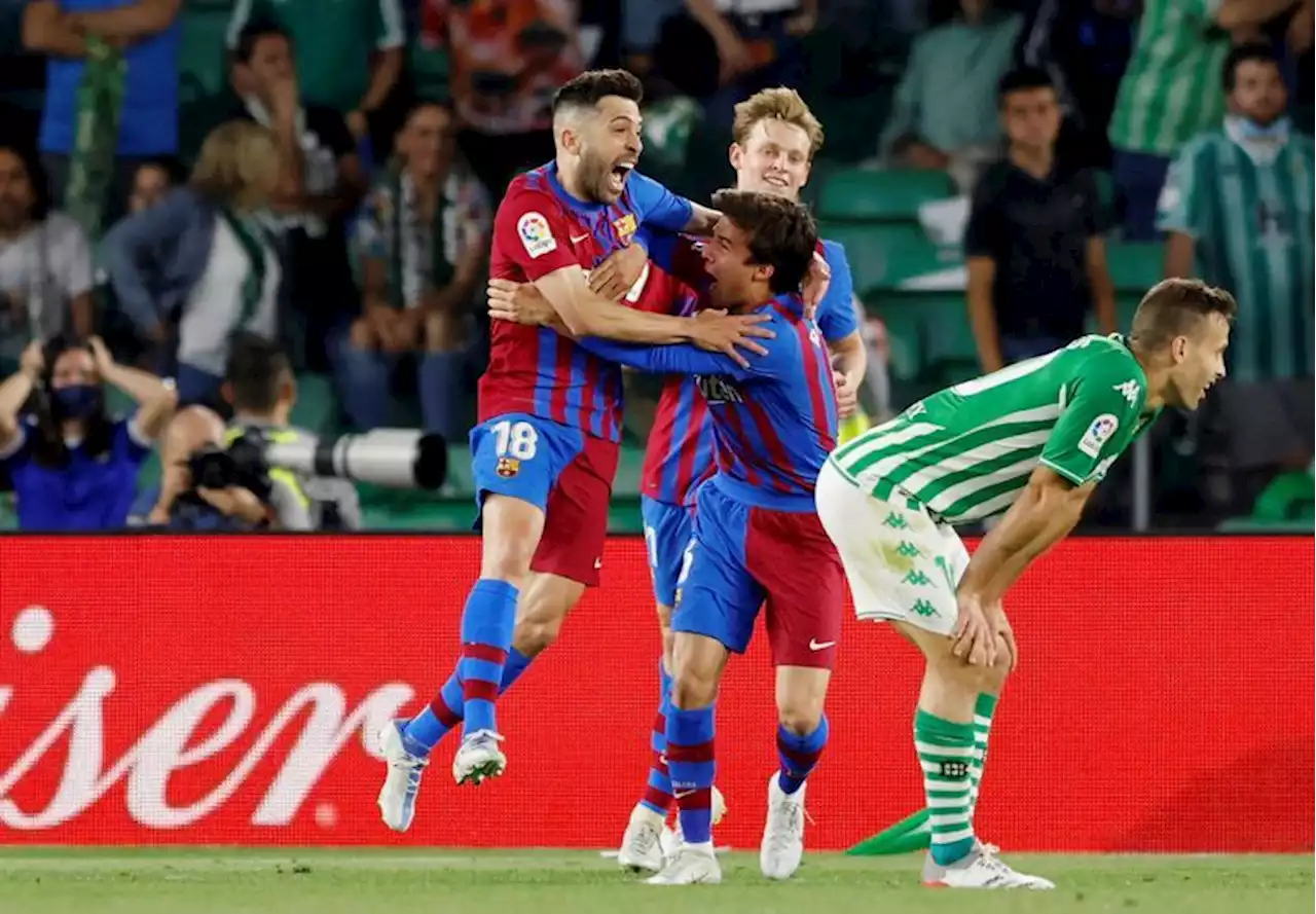 Soccer-Barca secure Champions League spot with 2-1 Betis win