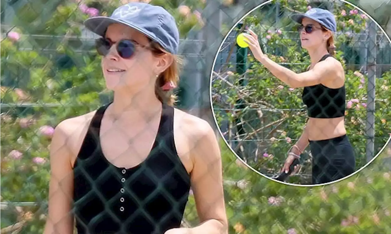 Emma Watson slips into a black crop top in Ibiza