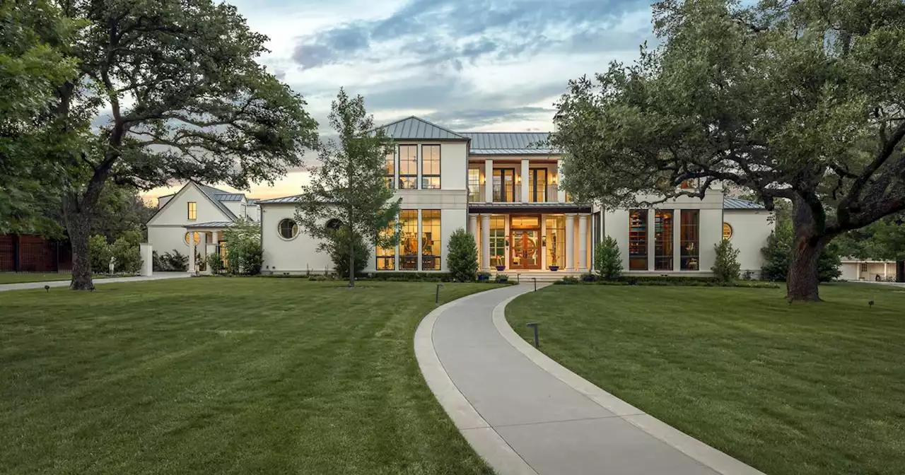 See the two-story library in this custom Preston Hollow home