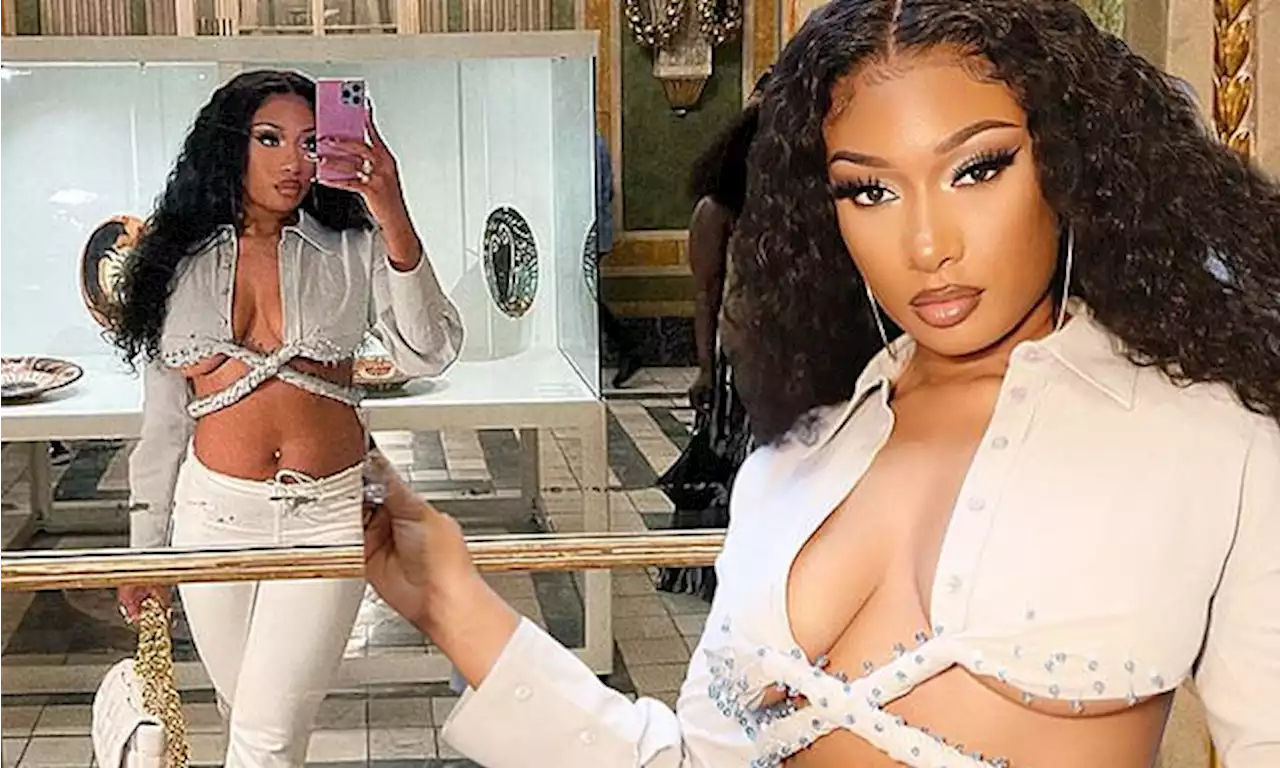 Megan Thee Stallion shows off her toned midriff in a white crop top