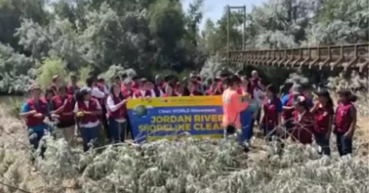 Volunteers work to clean up Jordan River shoreline