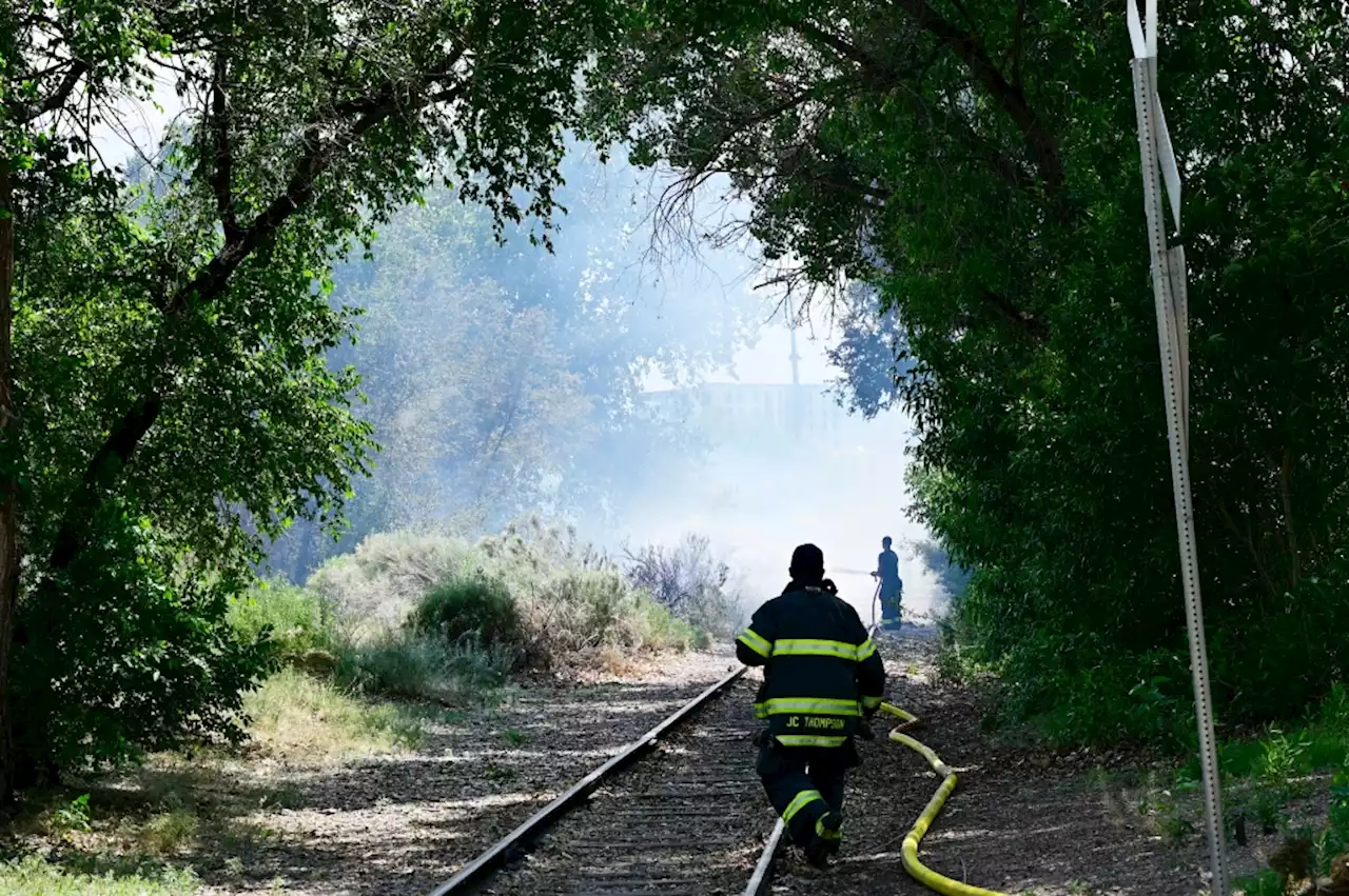 Grass fire near the Downtown Aquarium is doused by firefighters