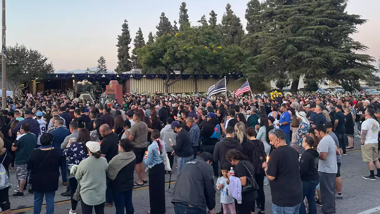 Hundreds gather for vigil remembering two California police officers killed in shootout