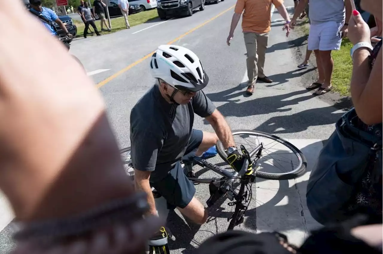 Biden takes spill while getting off bike after beach ride