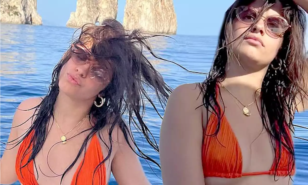 Camila Cabello poses in an orange bikini top in Italy