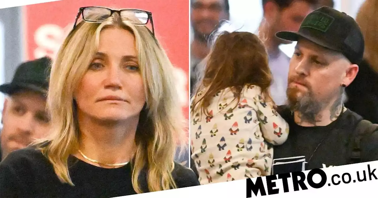 Cameron Diaz and Benji Madden carry daughter through airport in family outing