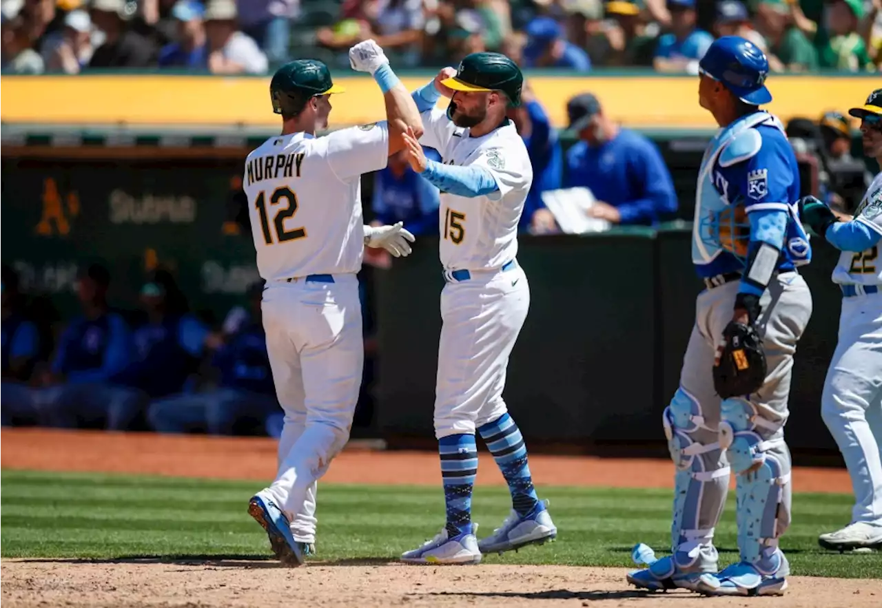 Two slumping Athletics break out in Sunday win over Royals