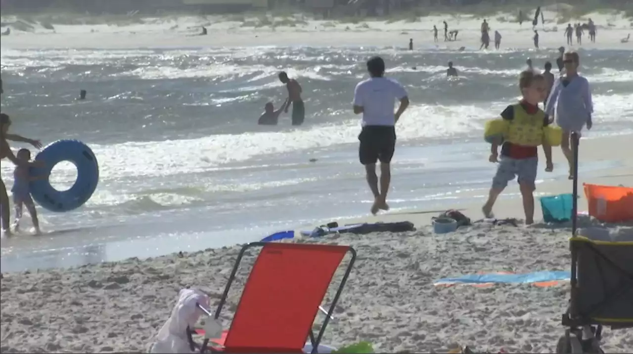 Locals & vacationers head to beach to find relief