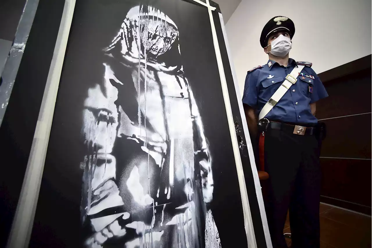 Eight men found guilty of stealing Banksy artwork from Paris attack site