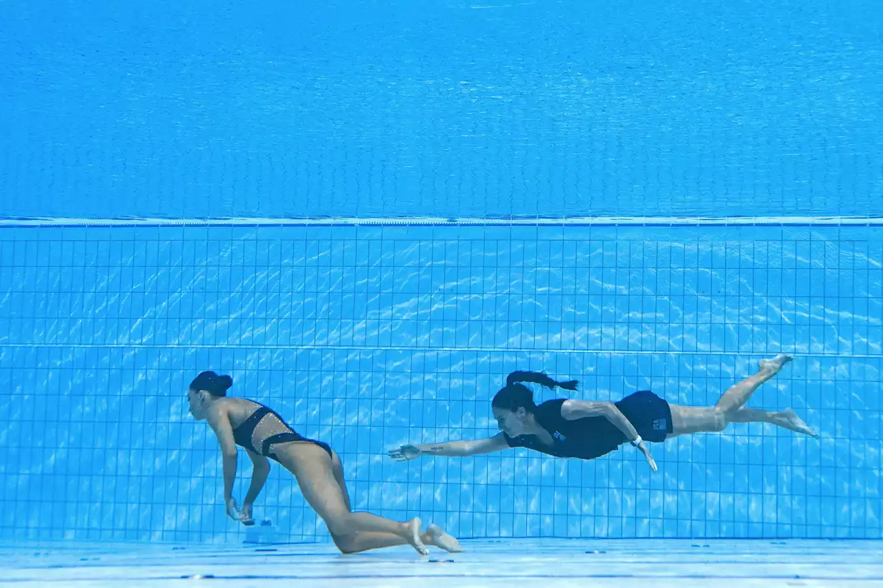 Swimmer's hero coach dives into pool to save her life after she fainted in water