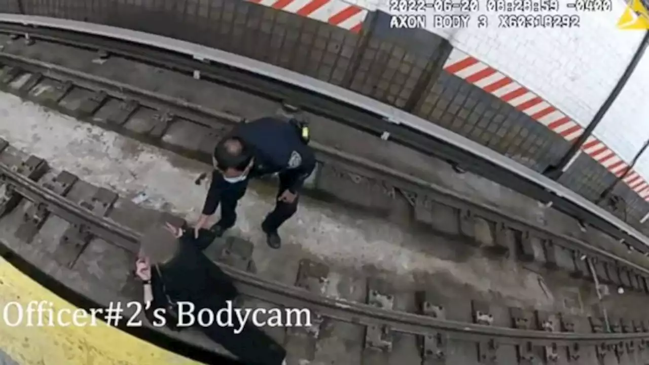 Police officers save woman who fainted and fell onto New York City subway tracks