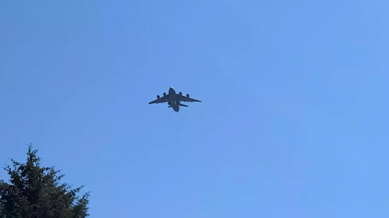 Air Force plane practices landings on a clear Juneau day