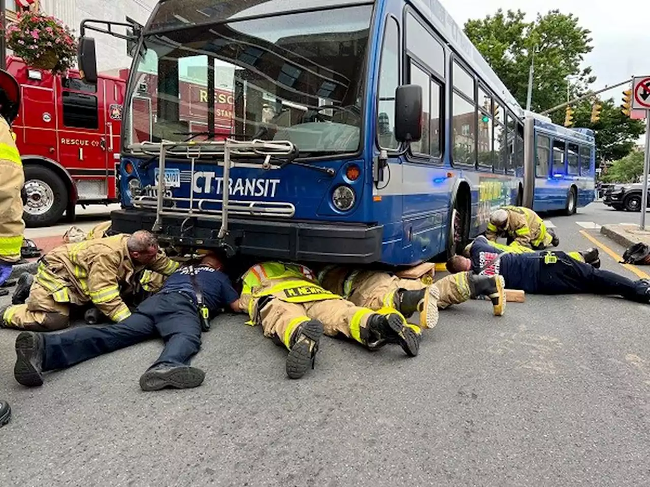 WATCH: Firefighters rescue woman trapped under public transit bus