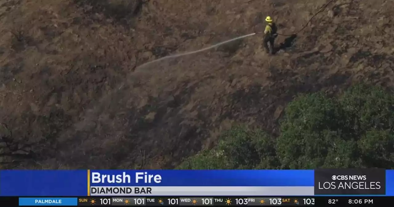 Brush fire in Diamond Bar threatens structures before being stopped by firefighters