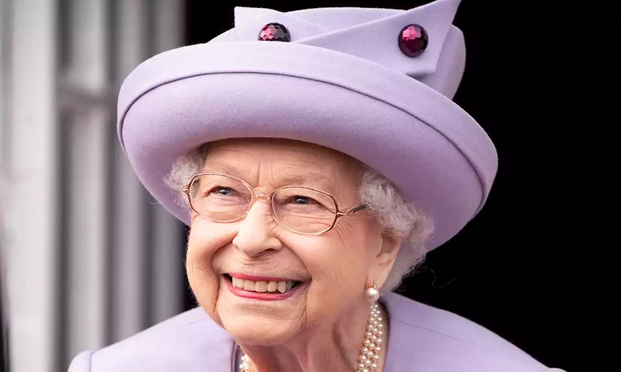 The Queen beams with joy as she presents George Cross to NHS representatives