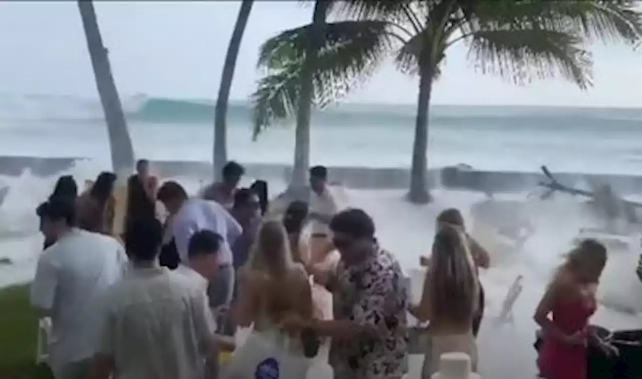 WATCH: Waves crash over wedding reception!