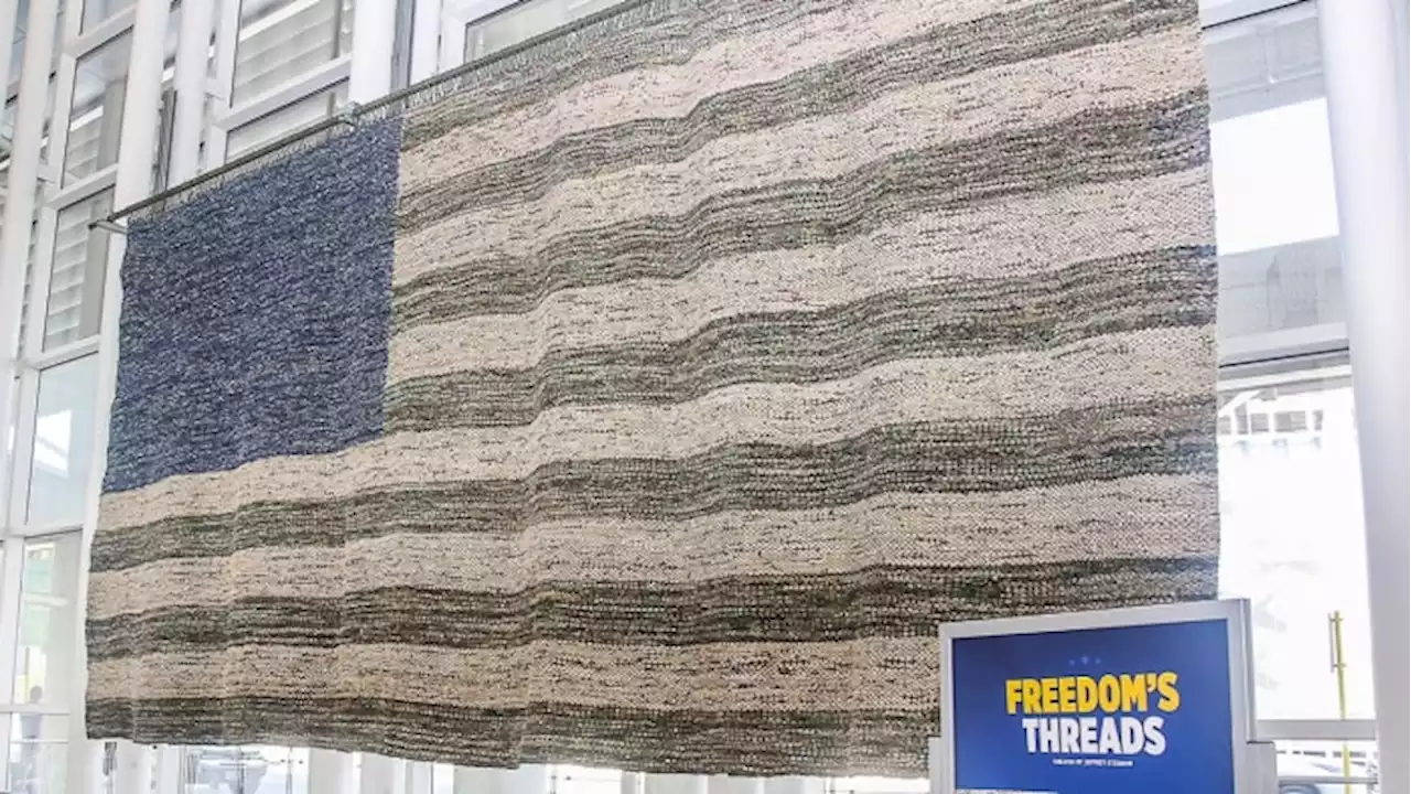 Flag woven from military uniforms on display at San Antonio International Airport