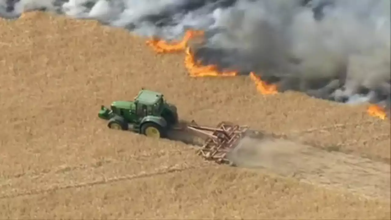 Incredible moment farmer tries to slow down wildfire to save neighbour's home