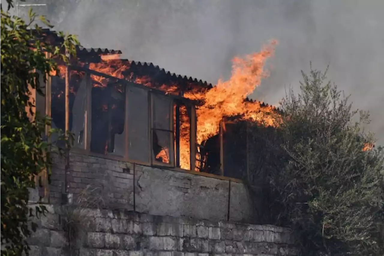 Fire damages homes in southern Greece; more blazes active