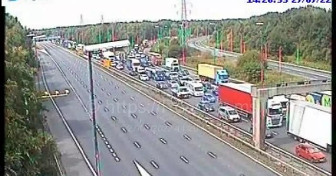 M6 rush hour chaos after car goes over central reservation injuring four people