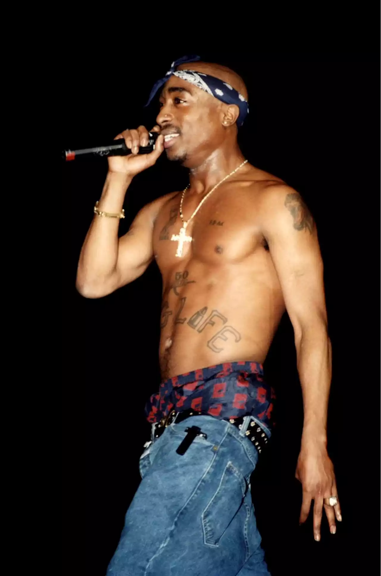 From workwear and 90s sweater vests to THAT bandana, here’s Tupac’s most iconic outfits