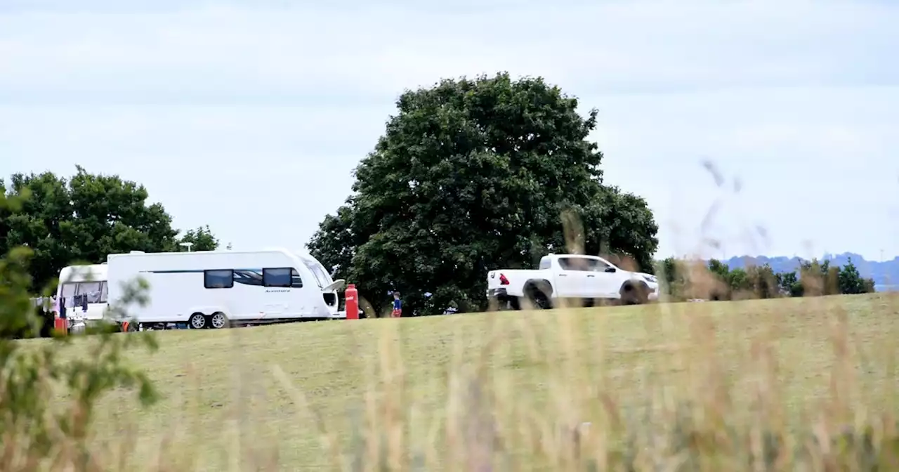 Large group of travellers pitch up at woodlands