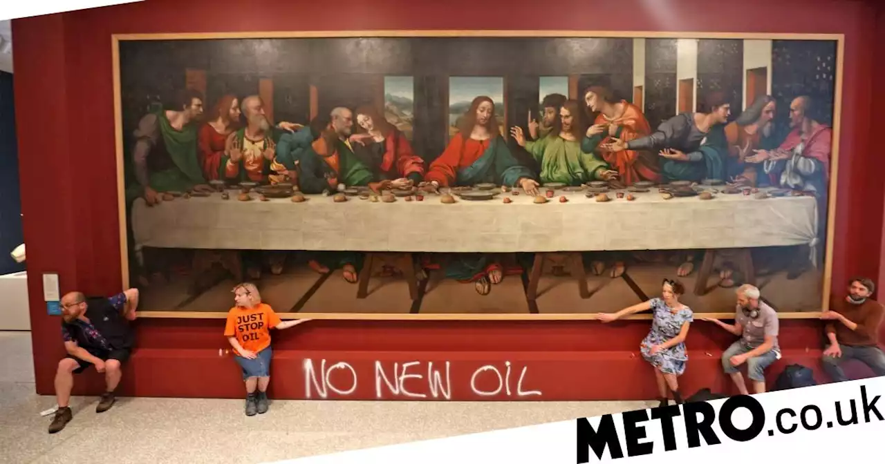 Protesters glue themselves to The Last Supper painting at Royal Academy