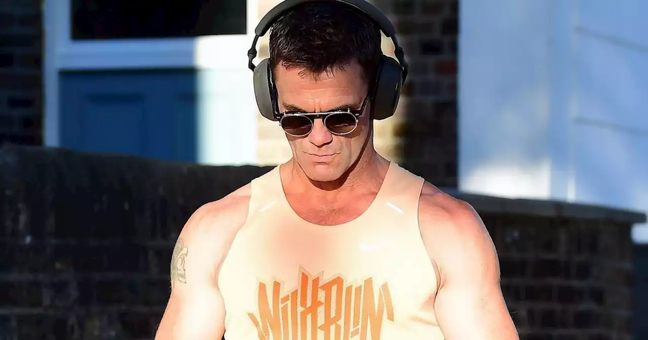 EastEnders star Scott Maslen flaunts his impressive muscles on London stroll