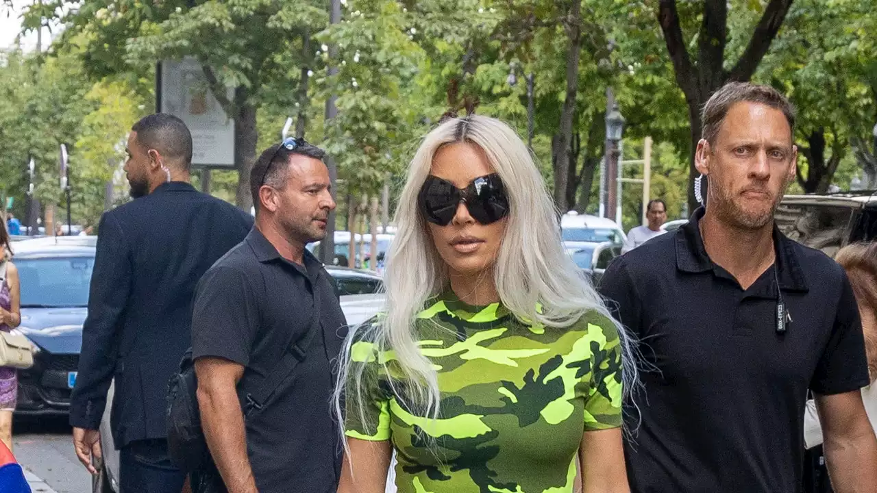 Kim Kardashian Lands At Couture Fashion Week In Lime-Green Camo Print