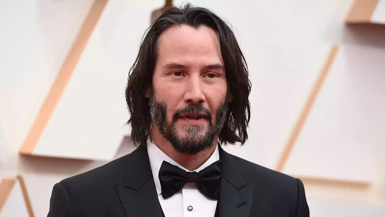 Keanu Reeves patiently answers fan's questions at the airport - and then asks some back