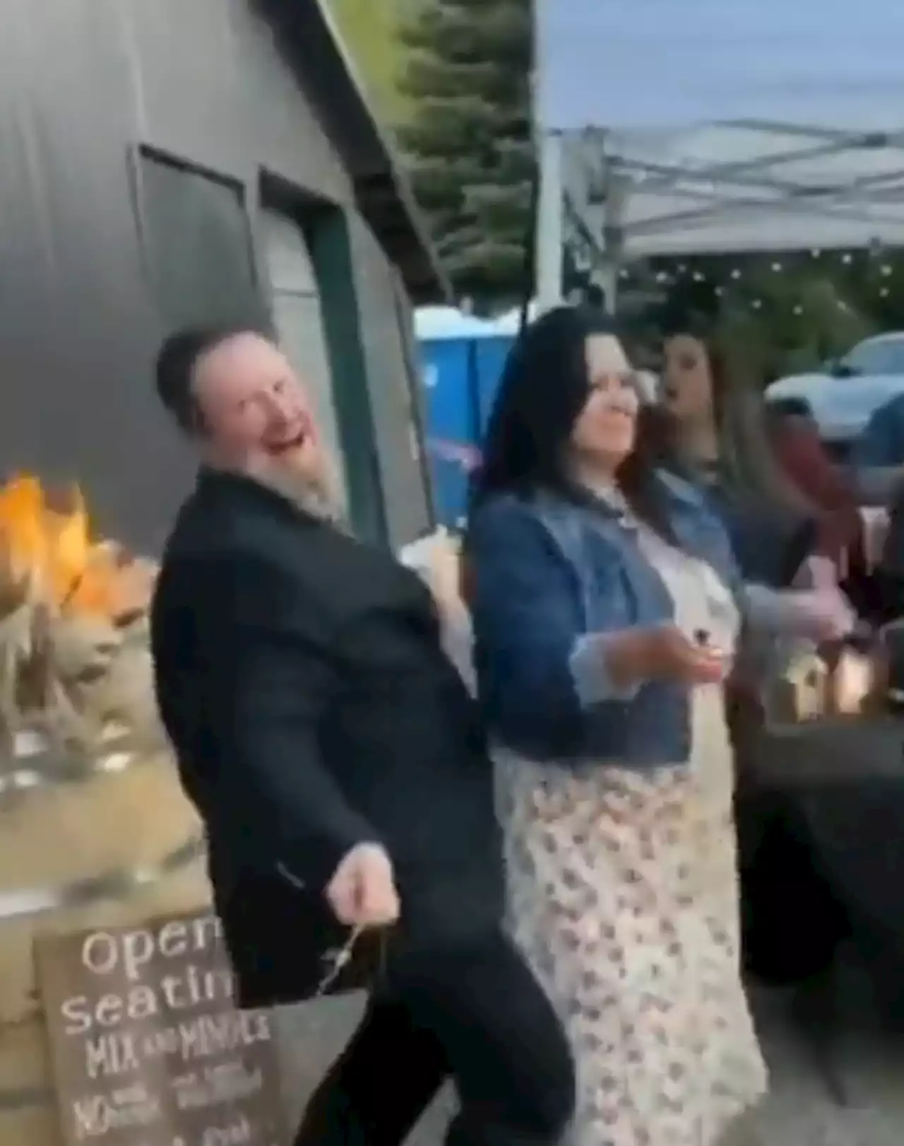 Watch as 'drunk' guest almost burns down wedding venue... but keeps dad-dancing