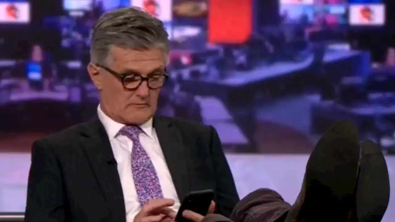 Moment BBC News anchor scrolls through phone with feet up on live TV