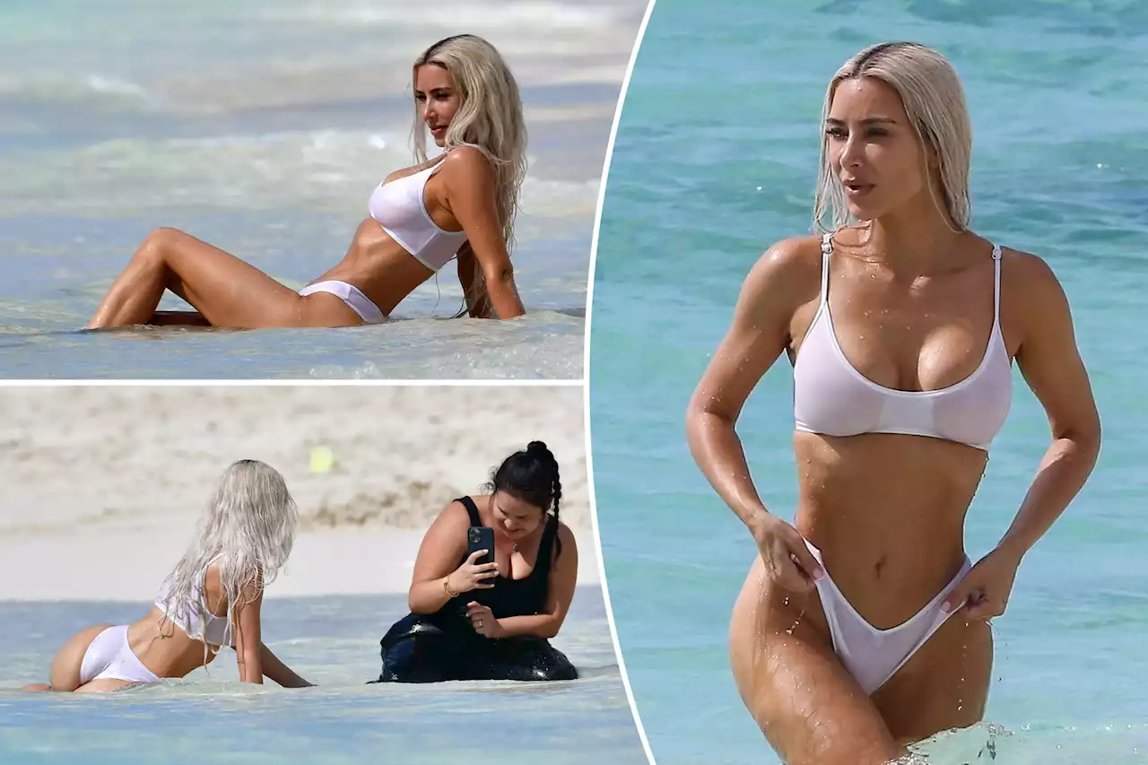 Kim Kardashian flaunts slimmed-down beach body in white hot bikini