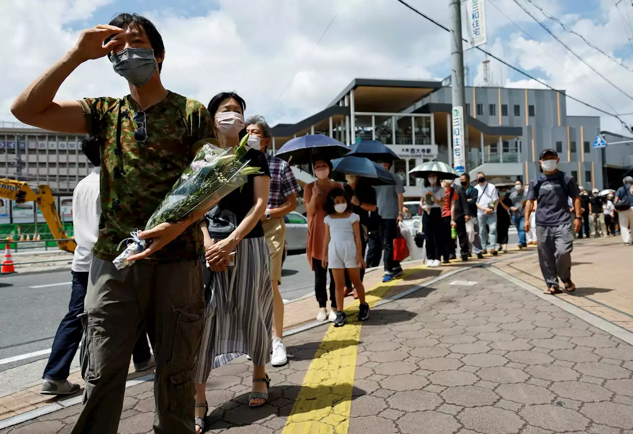 Abe's body returns to his home as Japan grieves for slain ex-PM