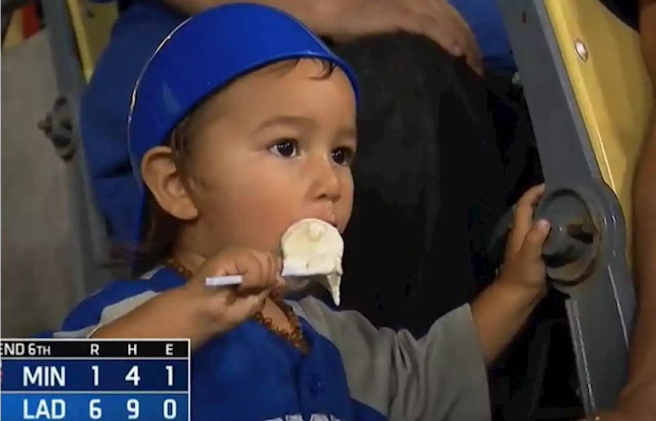 Young boy completely enjoys his ice cream during Dodgers game