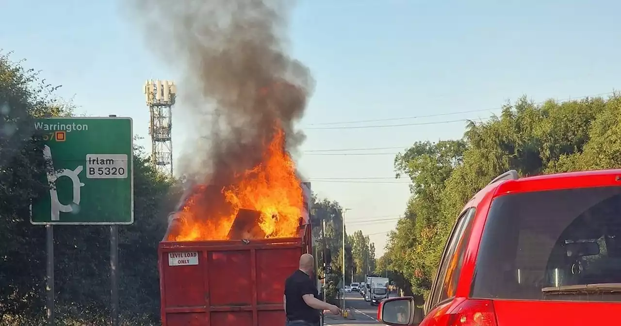 Major road closed and firefighters at scene after skip lorry goes up in flames