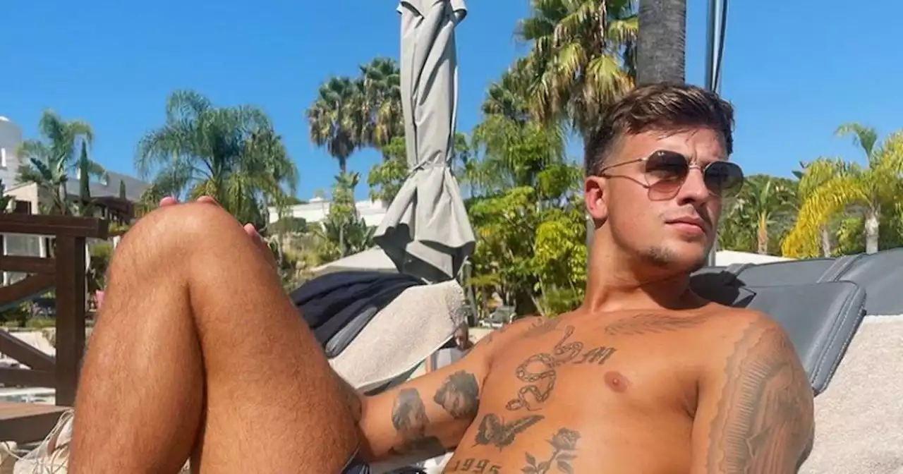 Love Island's Luca supports Gemma as he poses in her swimwear range on holiday