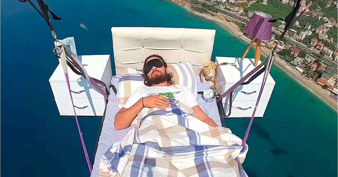 Paraglider Sleeps on a Bed While Flying Over the Mediterranean Sea