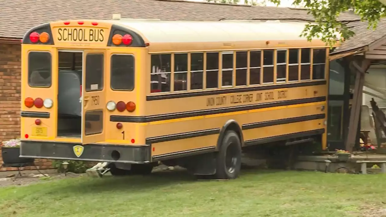 School bus carrying 30 students crashes into Indiana home, officials say