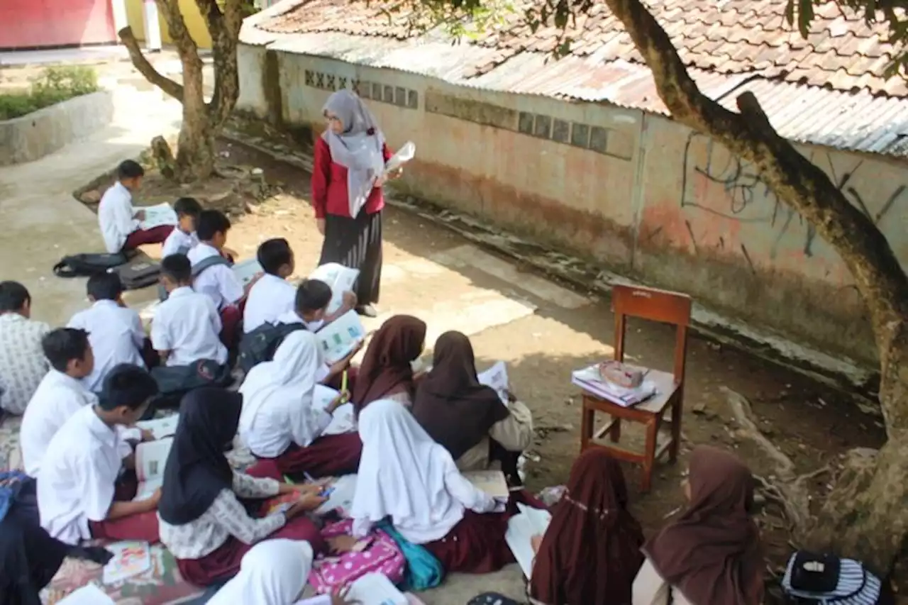 Murid sekolah terpaksa belajar bawah pokok