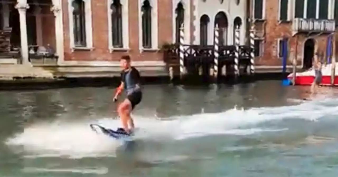 Tourists fined for surfing along Venice's Grand Canal