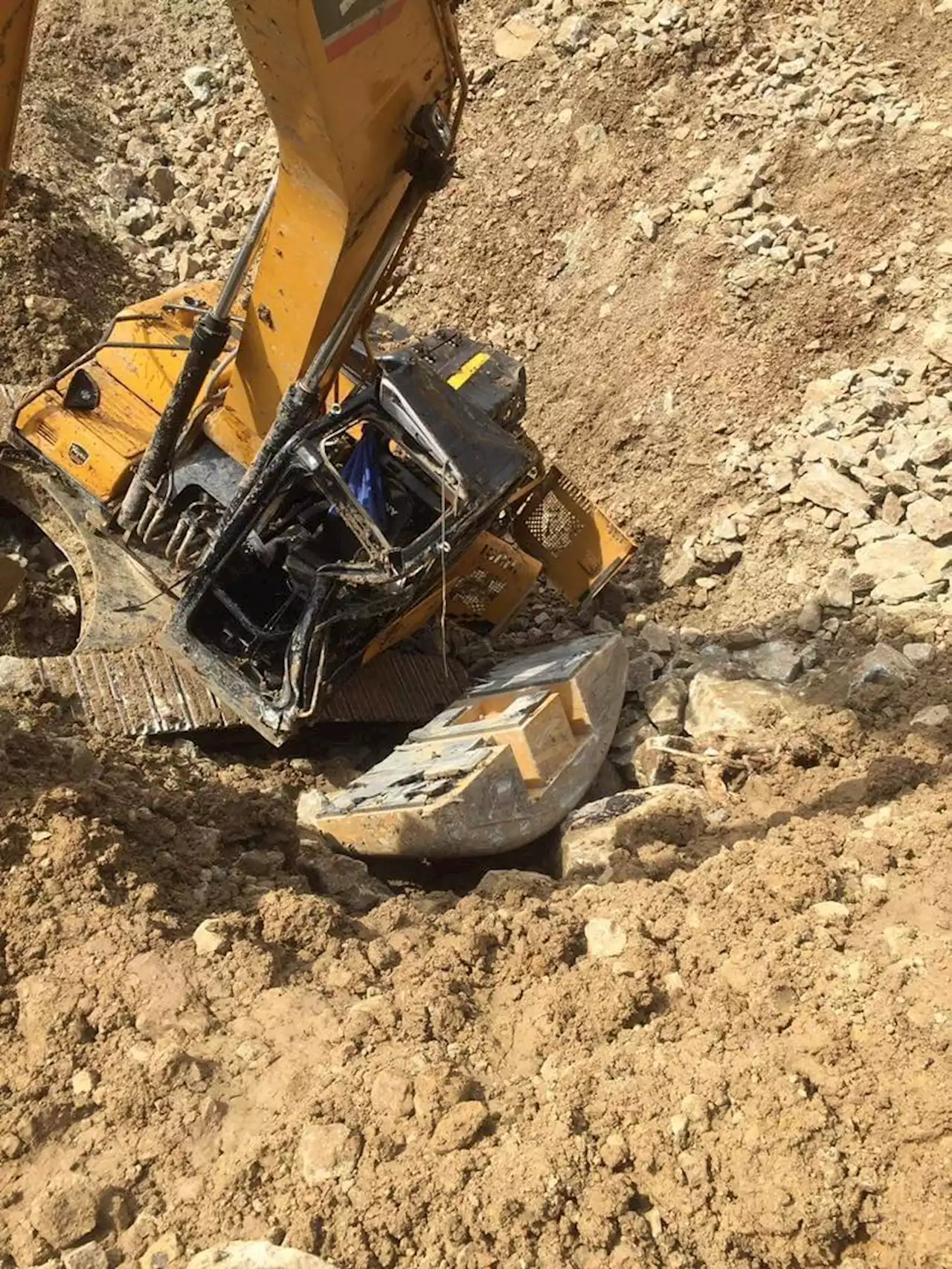 Worker injured after backhoe fell into a 60-foot cliff in Cebu City barangay