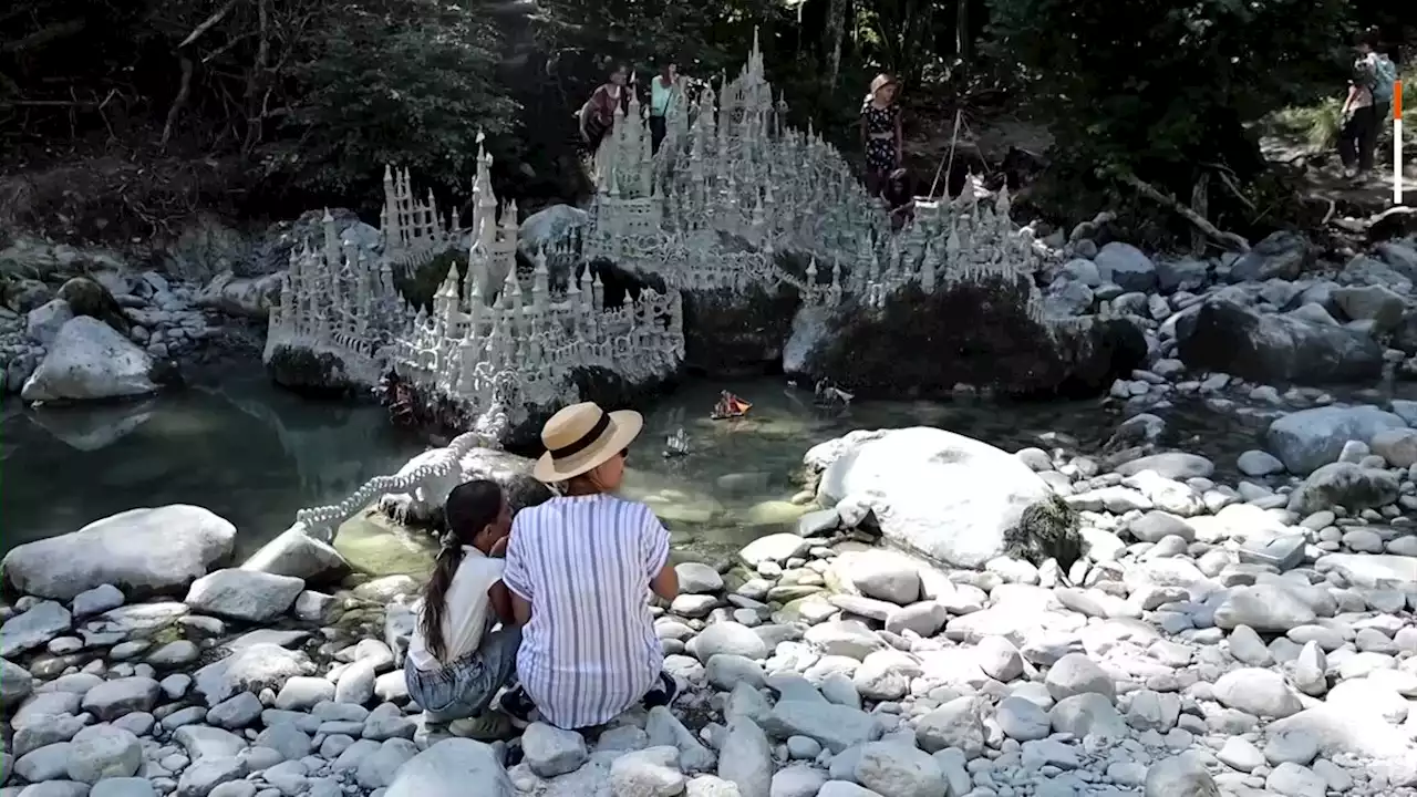 Swiss artist sculpts sprawling model castle on dried river bank