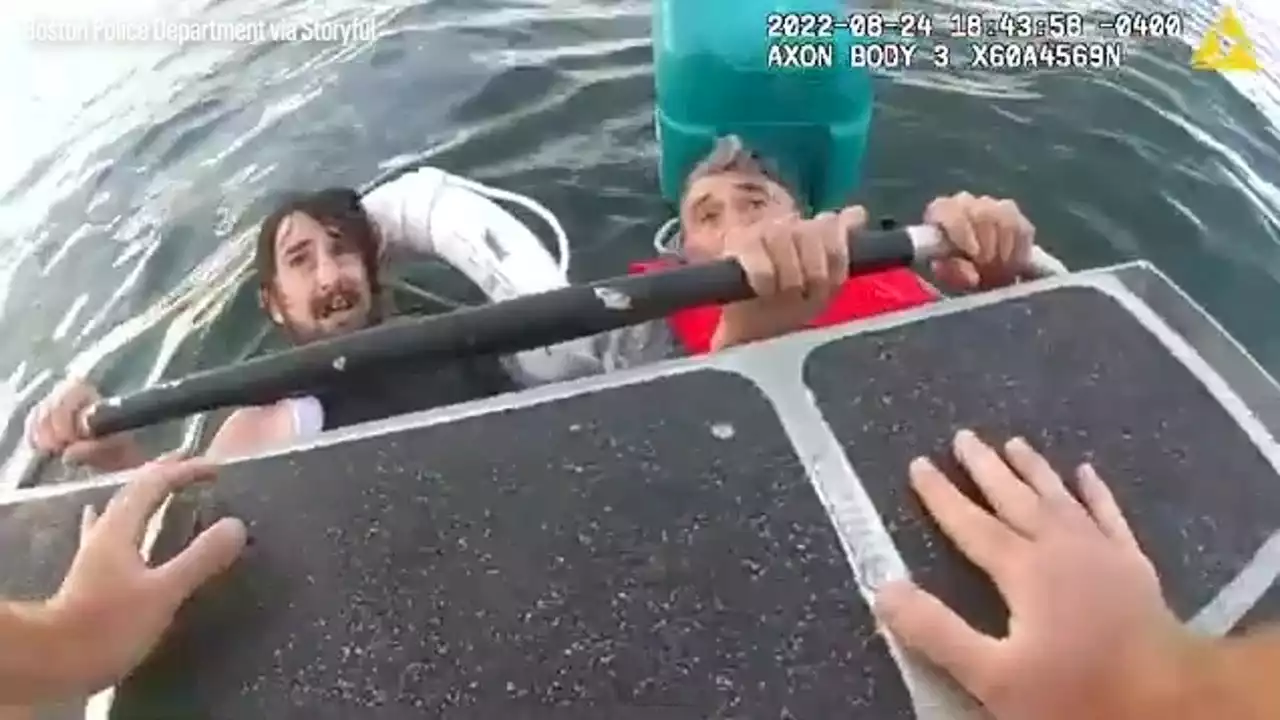 Watch: Police rescue father and son clinging to cooler in Boston Harbor