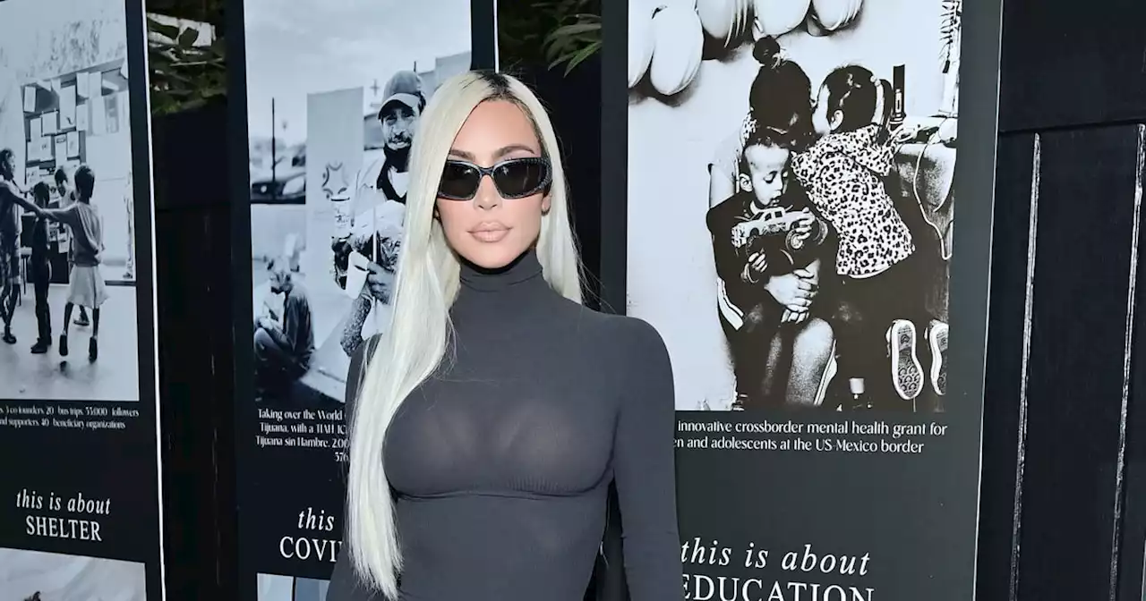 Kim Kardashian Styles a Gray Turtleneck Dress With Shield Sunglasses and Neon Boots