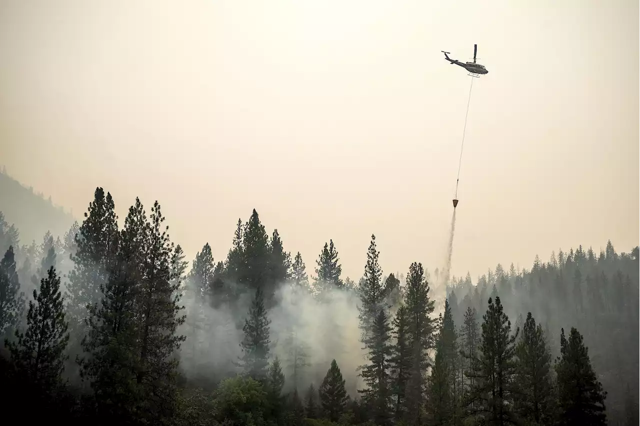 Firefighters partially surround deadly California fire