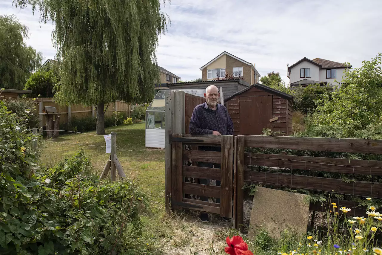 Moment ex-policeman grabs neighbour around throat in row over 6ft fence