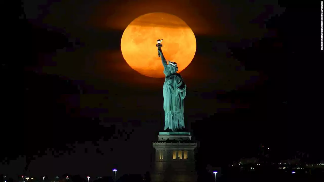 The harvest moon will glow an eerie orange color as it rises in the sky. Here's how to watch